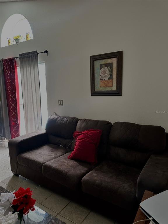 242 Durango Loop Street Davenport, FL 33897 - Photo 23 of 30 a living room with furniture and a window