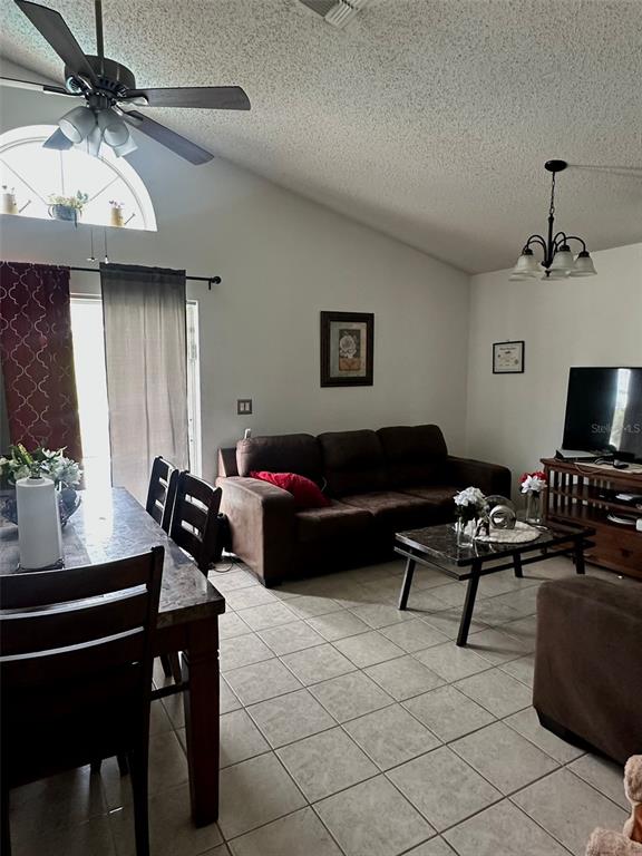242 Durango Loop Street Davenport, FL 33897 - Photo 27 of 30 a living room with furniture and a flat screen tv