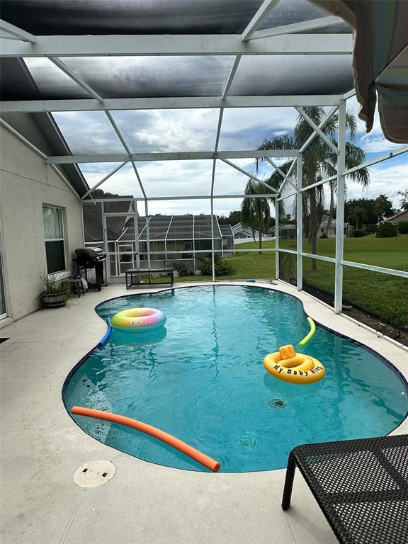 242 Durango Loop Street Davenport, FL 33897 - Photo 28 of 30 a view of a swimming pool with a patio and a yard
