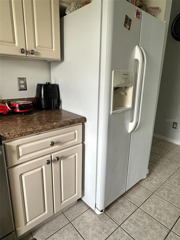 242 Durango Loop Street Davenport, FL 33897 - Photo 4 of 30 a kitchen with white cabinets and white appliances