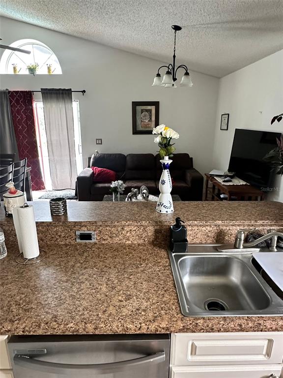 242 Durango Loop Street Davenport, FL 33897 - Photo 6 of 30 a kitchen sink stove and refrigerator