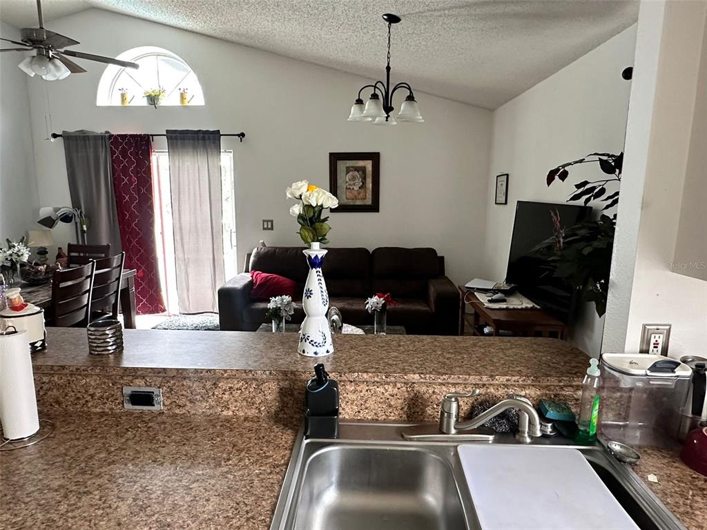 242 Durango Loop Street Davenport, FL 33897 - Photo 7 of 30 a room with furniture or chandelier and a wooden floor