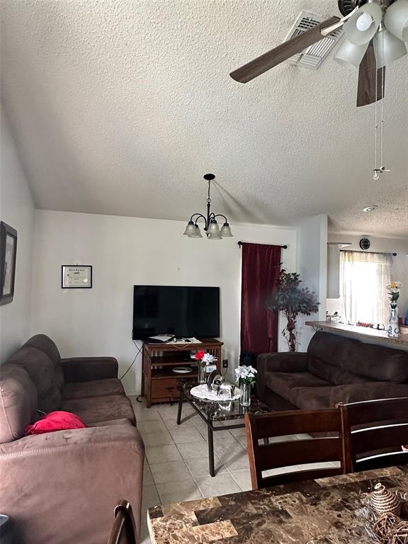 242 Durango Loop Street Davenport, FL 33897 - Photo 10 of 30 a living room with furniture a flat screen tv and a fireplace