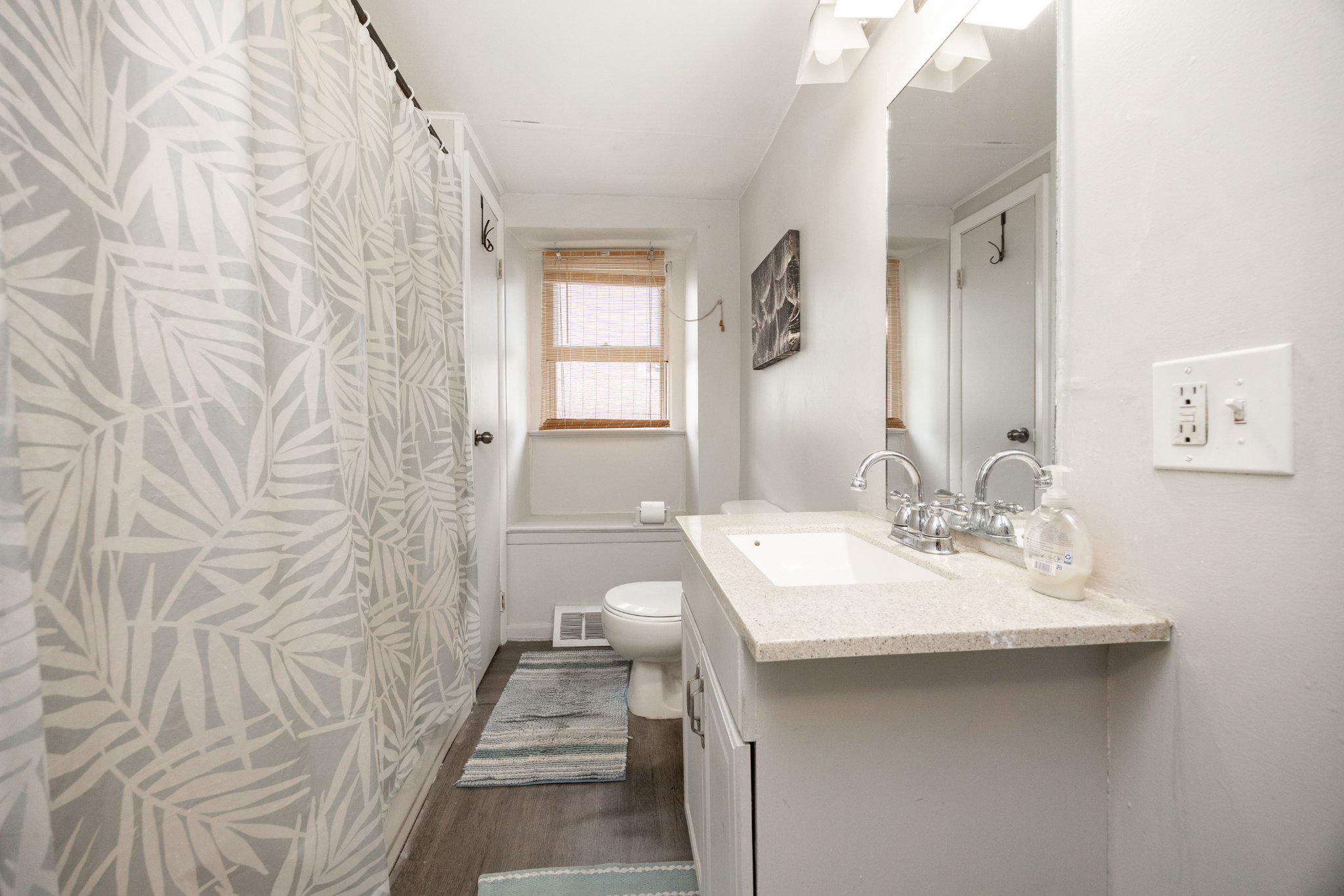 314 New Street Spring City, PA 19475 - Photo 11 of 16 a bathroom with a sink a mirror and a shower