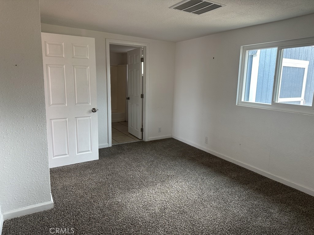 34929 Cedar Road Barstow, CA 92311 - Photo 13 of 22 an empty room with windows and closet