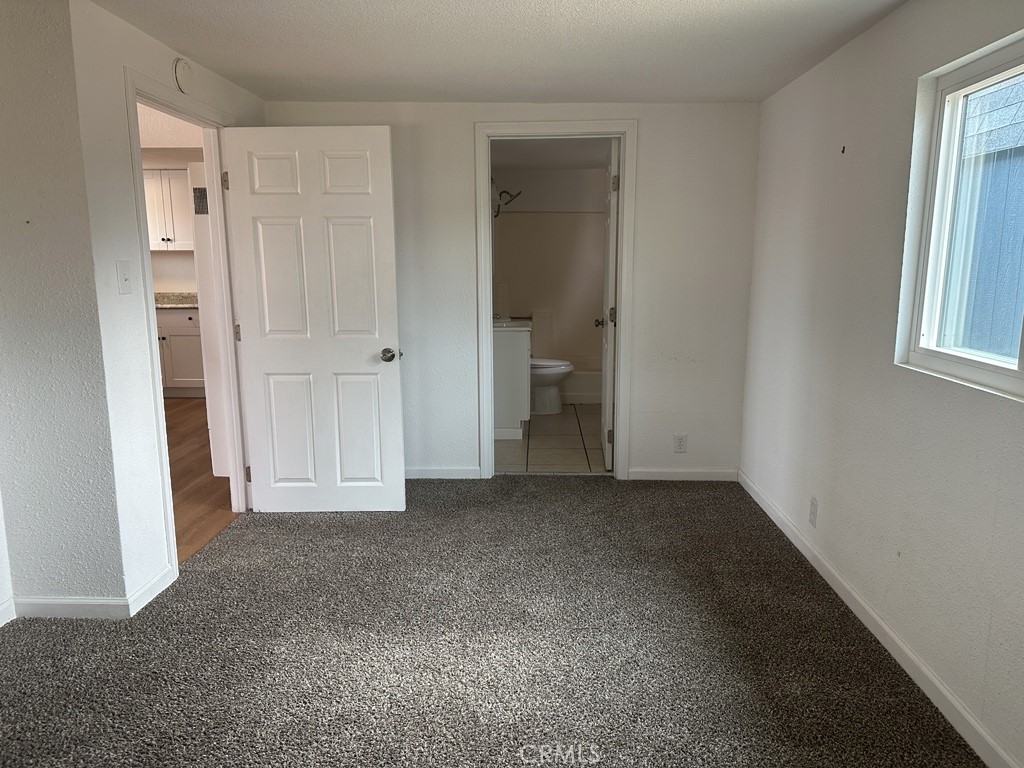 34929 Cedar Road Barstow, CA 92311 - Photo 15 of 22 an empty room with windows and closet