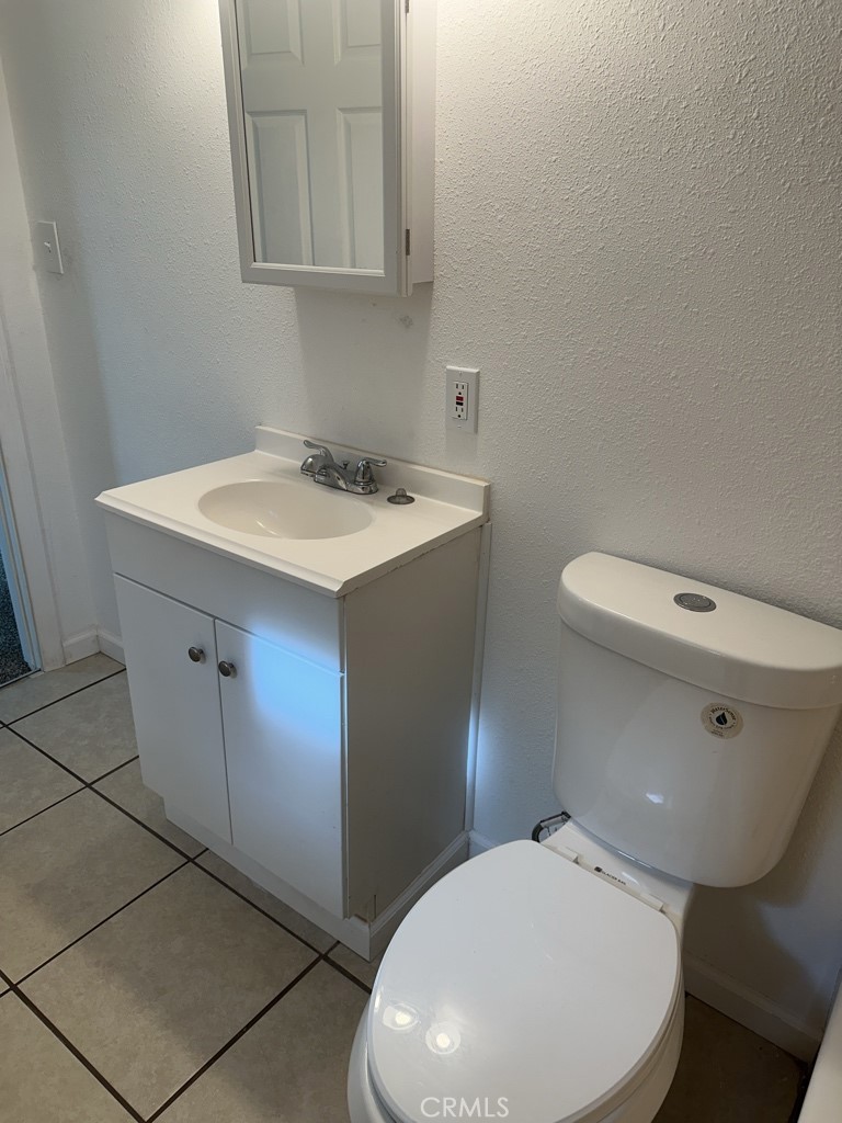 34929 Cedar Road Barstow, CA 92311 - Photo 21 of 22 a bathroom with a toilet sink and mirror