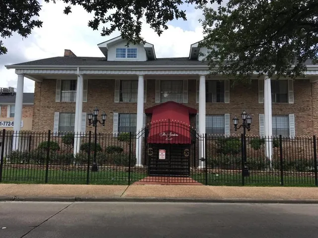 a view of a house with a yard and a street