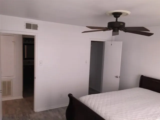 a bathroom with a granite countertop toilet sink and mirror
