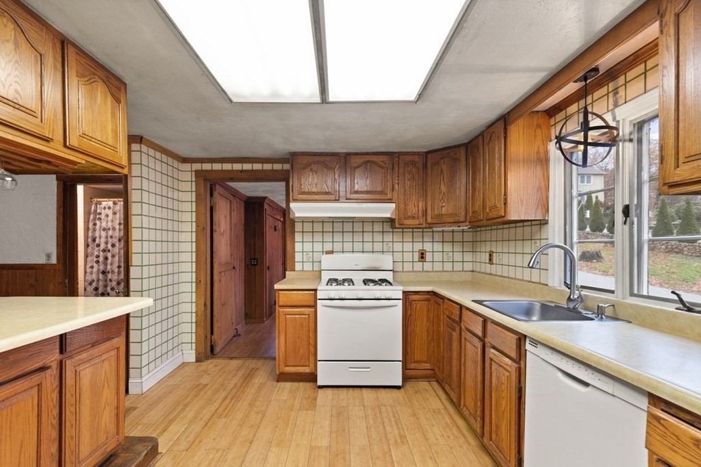 119 River Street Middleton, MA 01949 - Photo 13 of 31 a kitchen with a sink stove and cabinets