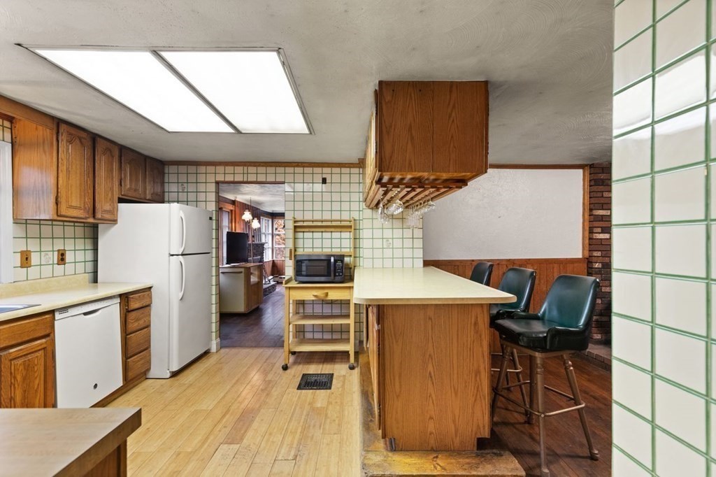 119 River Street Middleton, MA 01949 - Photo 14 of 31 a kitchen with stainless steel appliances kitchen island a stove a refrigerator a oven with white cabinets and wooden floor