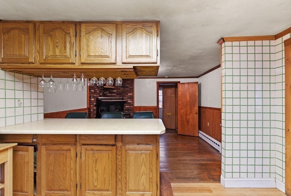 119 River Street Middleton, MA 01949 - Photo 15 of 31 a kitchen with kitchen island granite countertop wooden cabinets and a stove