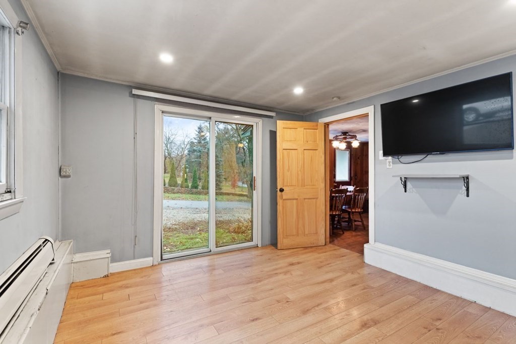 119 River Street Middleton, MA 01949 - Photo 20 of 31 a view of a livingroom with wooden floor and a flat screen tv