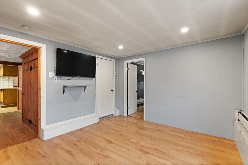 119 River Street Middleton, MA 01949 - Photo 22 of 31 a view of a livingroom with wooden floor and a flat screen tv