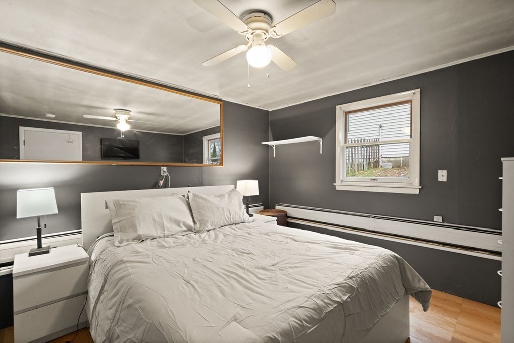 119 River Street Middleton, MA 01949 - Photo 24 of 31 a bedroom with a bed and a lamp