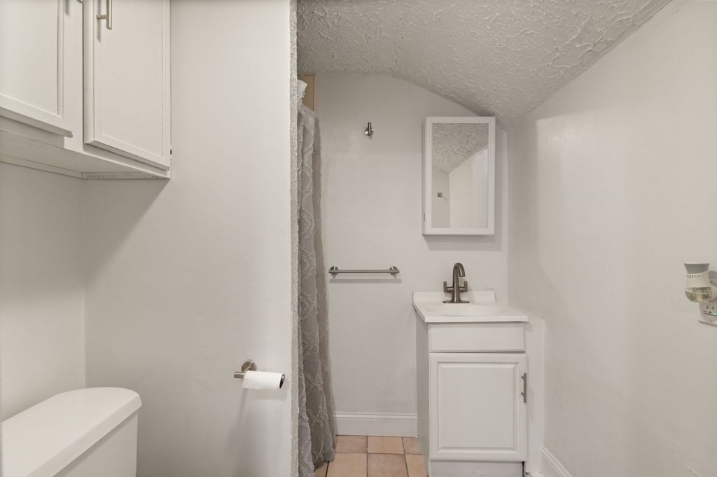 119 River Street Middleton, MA 01949 - Photo 26 of 31 a bathroom with a sink toilet and vanity
