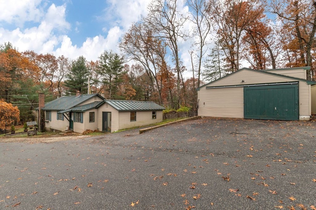 119 River Street Middleton, MA 01949 - Photo 28 of 31 a front view of a house with a garden and trees