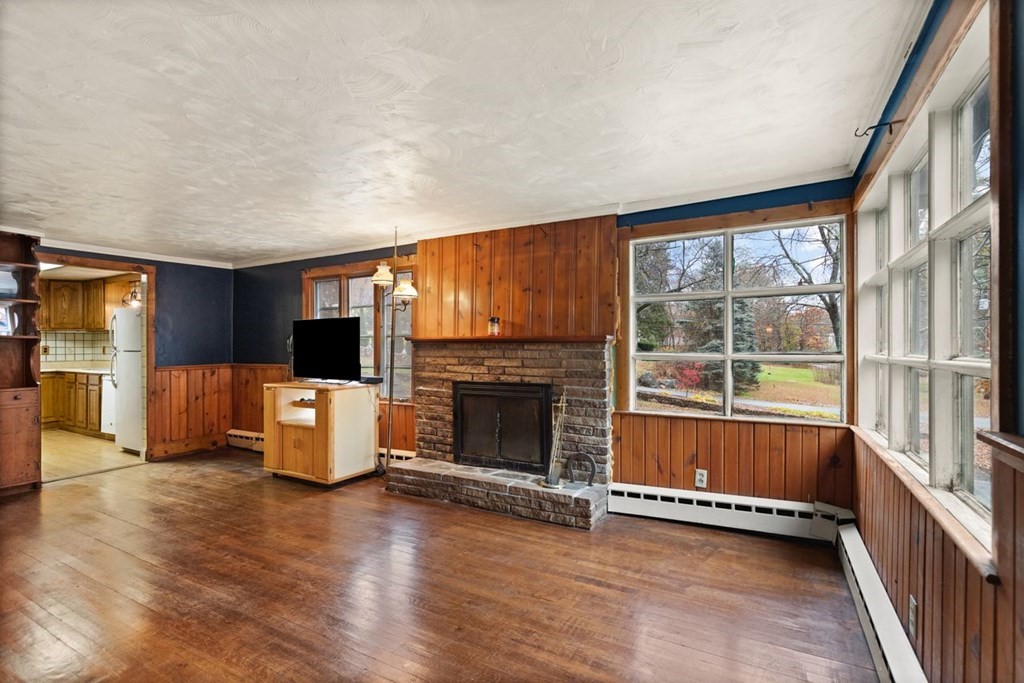 119 River Street Middleton, MA 01949 - Photo 5 of 31 a view of a livingroom with furniture a fireplace and window