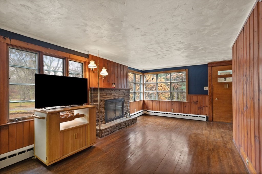 119 River Street Middleton, MA 01949 - Photo 6 of 31 a view of a livingroom with furniture and a flat screen tv