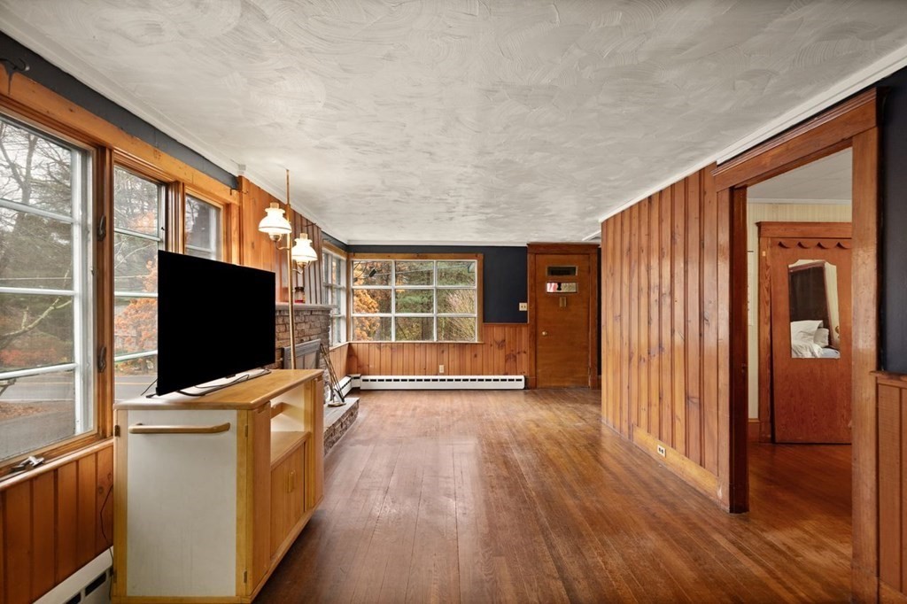 119 River Street Middleton, MA 01949 - Photo 7 of 31 a view of a flat screen tv with wooden floor