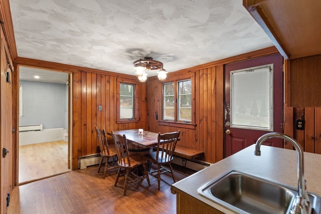 119 River Street Middleton, MA 01949 - Photo 9 of 31 a kitchen with a table chairs and a refrigerator