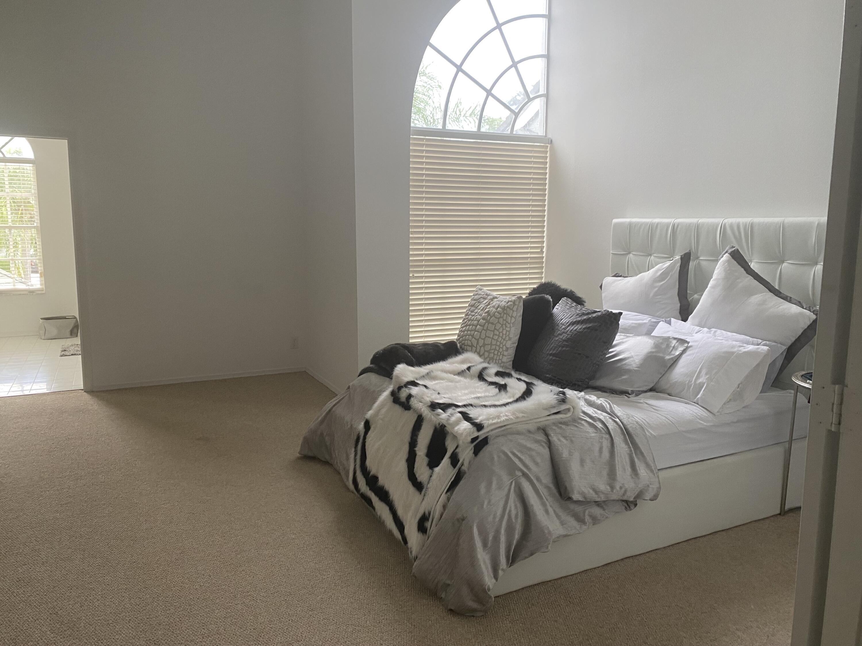 21530 St Andrews Grand Circle, Unit 27 Boca Raton, FL 33486 - Photo 12 of 18 a bedroom with a bed and a window