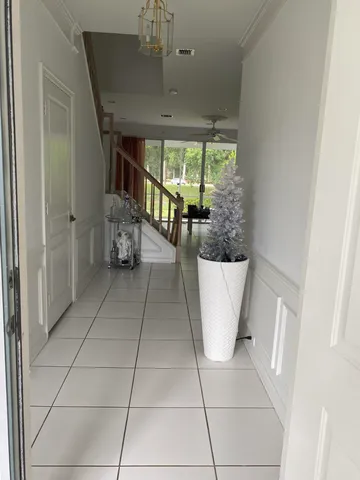 a view of a room with a large window and chandelier