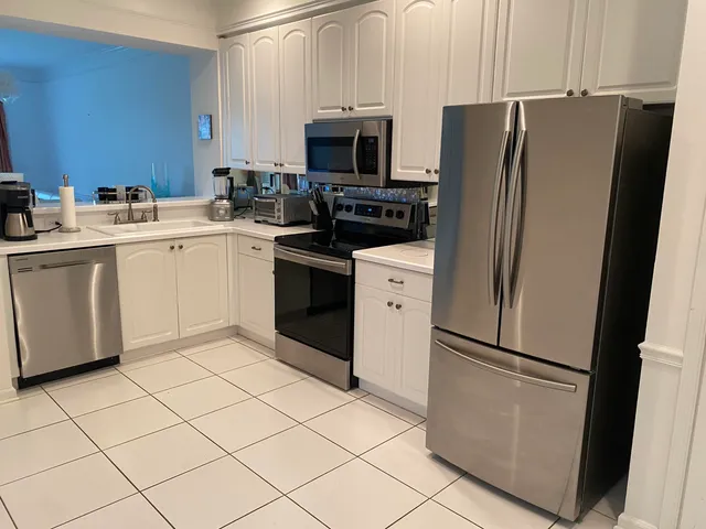 a kitchen with stainless steel appliances a refrigerator and a sink