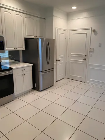 a kitchen with kitchen island granite countertop a sink a counter space and stainless steel appliances