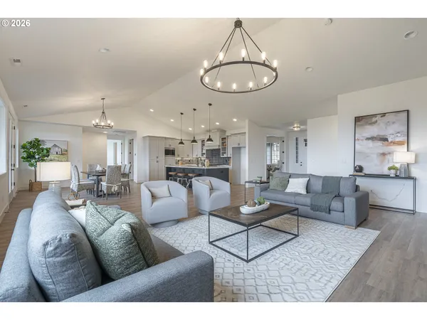 a living room with furniture kitchen and a chandelier