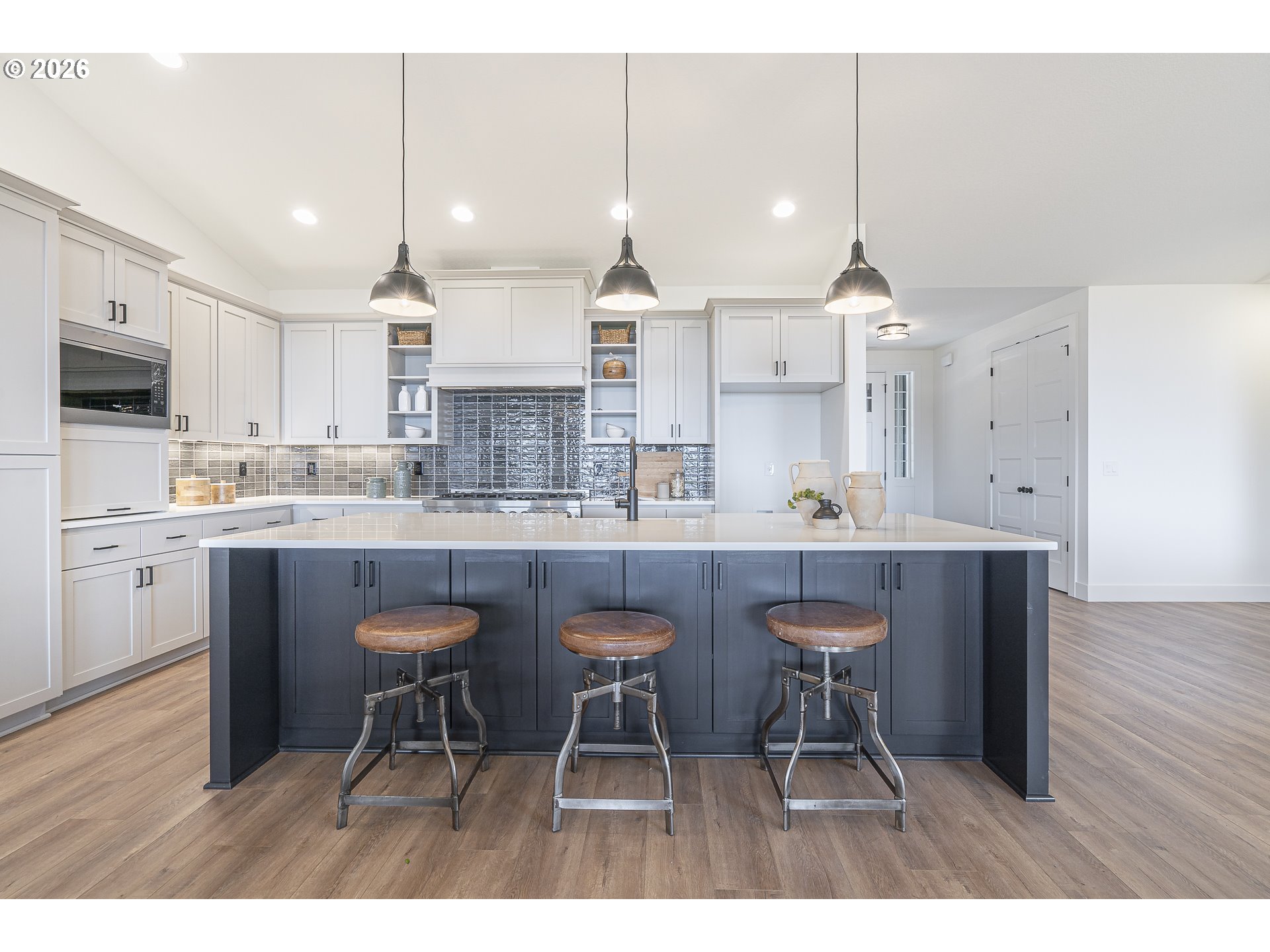 19350 Northeast Trunk Road Dundee, OR 97115 - Photo 9 of 14 a kitchen with stainless steel appliances granite countertop a sink a stove a refrigerator and a dining table with wooden floor