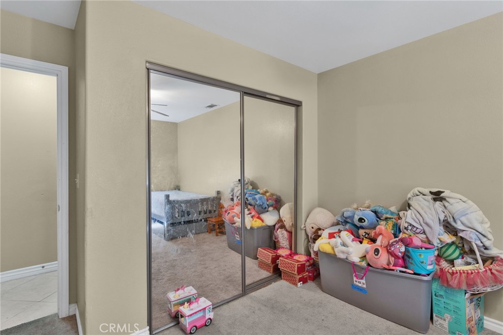 13597 Kiowa Road Apple Valley, CA 92308 - Photo 19 of 44 a living room with toys and a couch