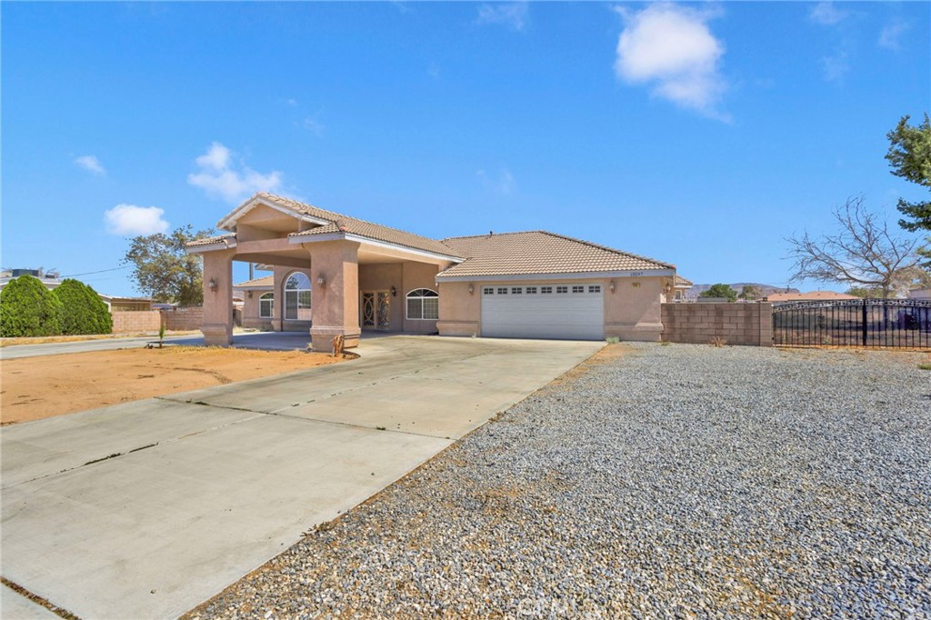 13597 Kiowa Road Apple Valley, CA 92308 - Photo 2 of 44 a front view of a house with a yard