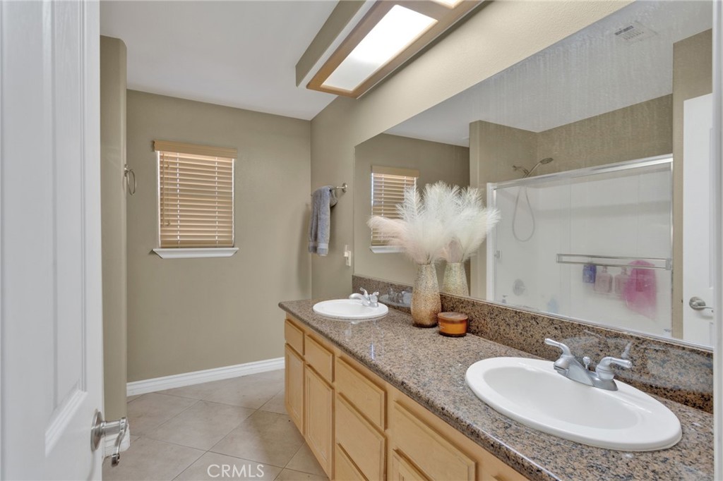 13597 Kiowa Road Apple Valley, CA 92308 - Photo 22 of 44 a bathroom with a granite countertop sink and a mirror