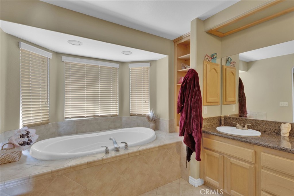 13597 Kiowa Road Apple Valley, CA 92308 - Photo 24 of 44 a bathroom with a tub sink and mirror
