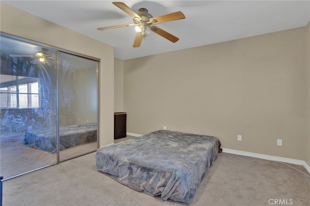 13597 Kiowa Road Apple Valley, CA 92308 - Photo 26 of 44 a bedroom with a bed and a chandelier