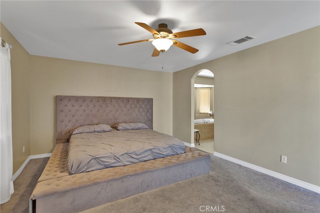 13597 Kiowa Road Apple Valley, CA 92308 - Photo 33 of 44 a bedroom with a bed and window