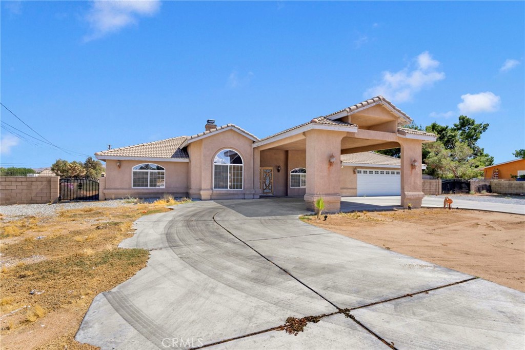 13597 Kiowa Road Apple Valley, CA 92308 - Photo 7 of 44 a view of a house with a yard and garage
