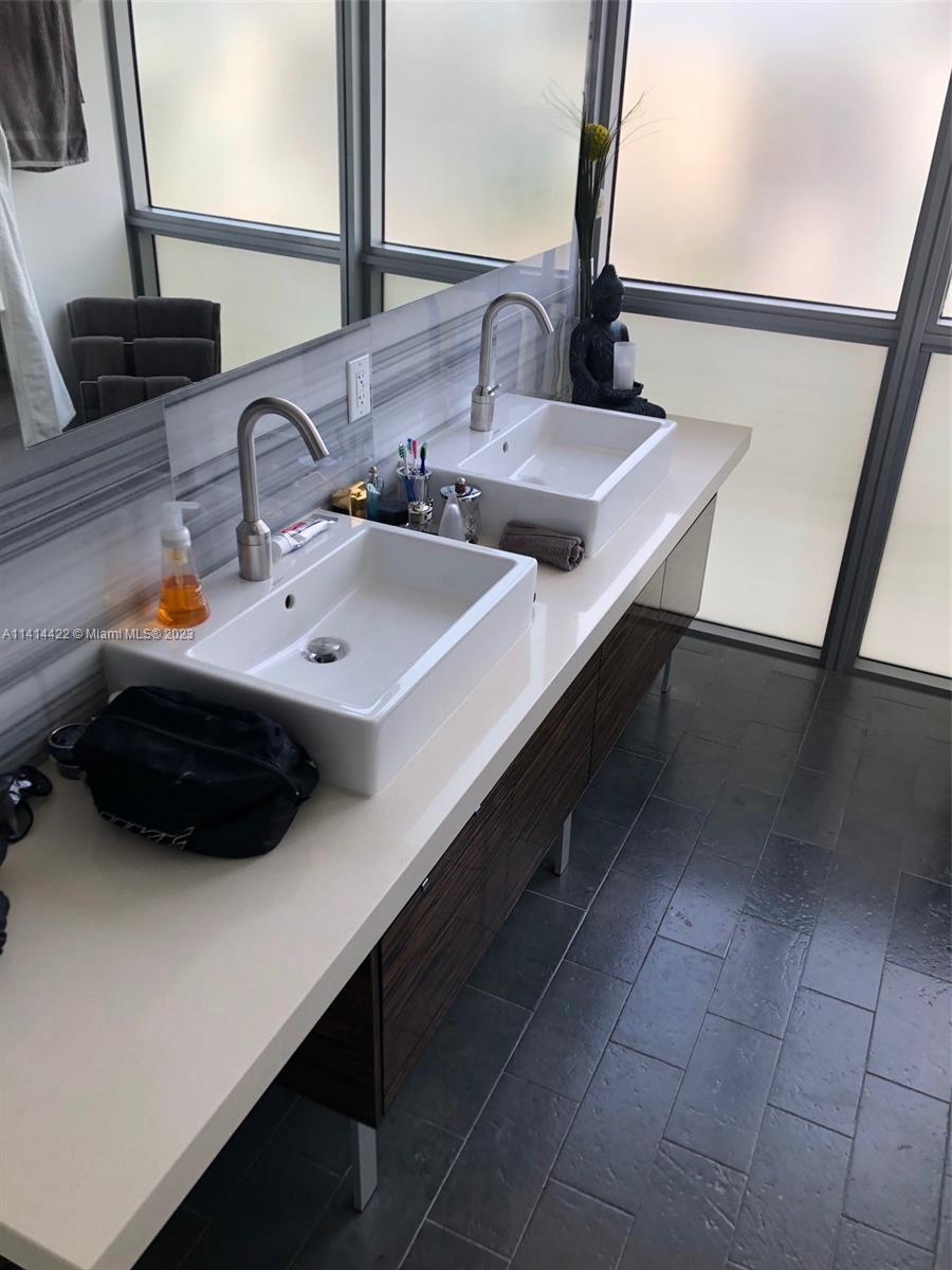 1100 Biscayne Boulevard, Unit 1505 Miami, FL 33132 - Photo 3 of 15 a bathroom with a sink and a mirror