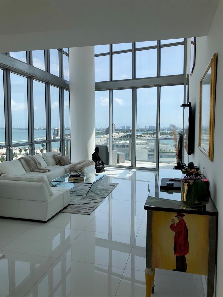 1100 Biscayne Boulevard, Unit 1505 Miami, FL 33132 - Photo 4 of 15 a living room with furniture and large windows
