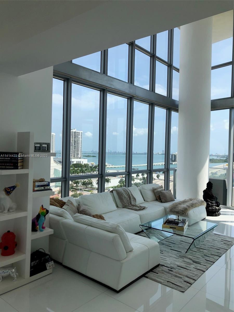 1100 Biscayne Boulevard, Unit 1505 Miami, FL 33132 - Photo 5 of 15 a living room with furniture and floor to ceiling windows