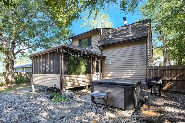 a view of a house with a yard and wooden deck