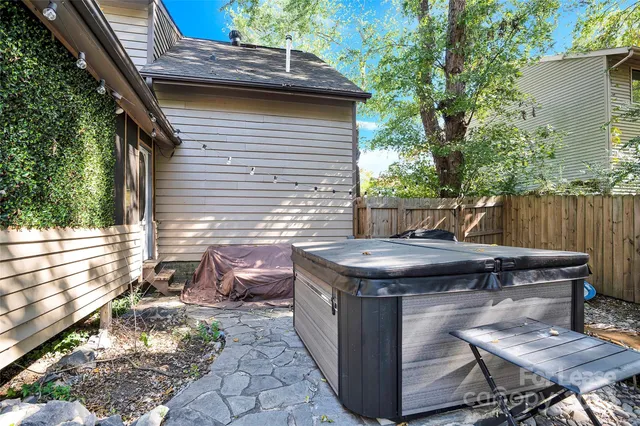 a view of a backyard with table and chairs with wooden fence