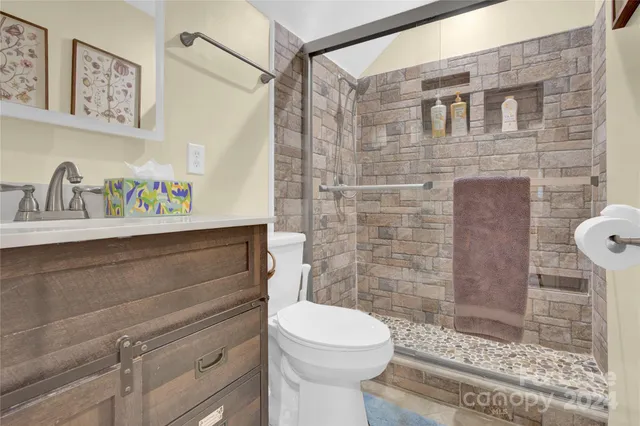 a bathroom with a sink a toilet and shower