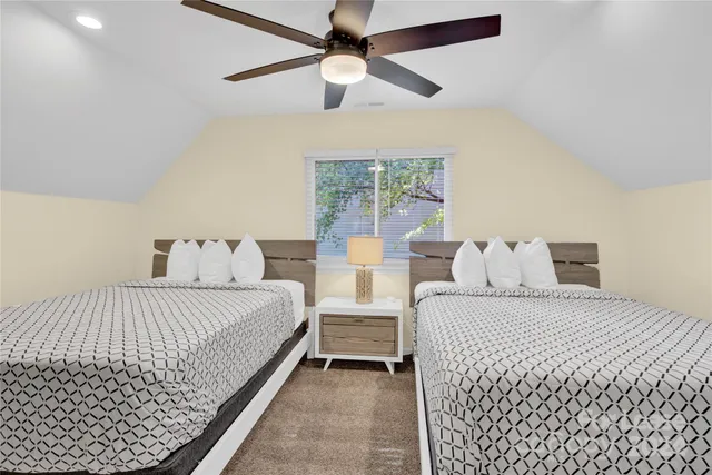 a bedroom with double bed and a chandelier