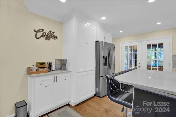a kitchen with kitchen island a refrigerator stove and sink