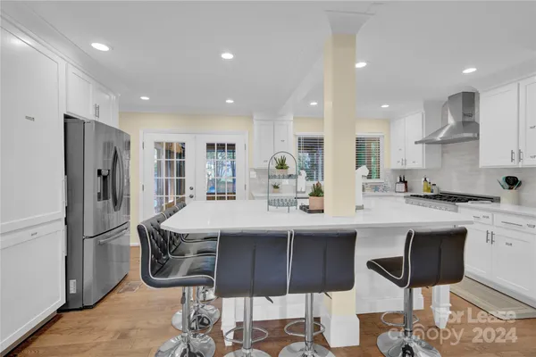 a kitchen with stainless steel appliances kitchen island granite countertop a sink and cabinets
