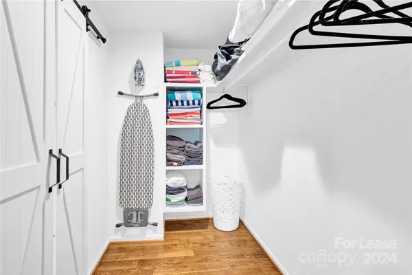 a view of a room with wooden floor and window