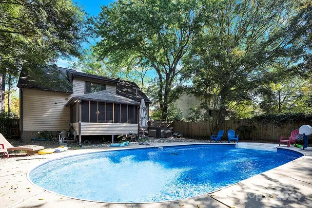 a view of a house with pool and sitting area