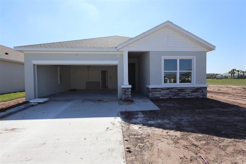 5113 Chapel Row Avenue Apollo Beach, FL 33572 - Photo 2 of 19 a front view of a house with garden